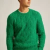Wollpullover mit Rundhalsausschnitt und Zopfmuster Wollpullover mit Rundhalsausschnitt und Zopfmuster